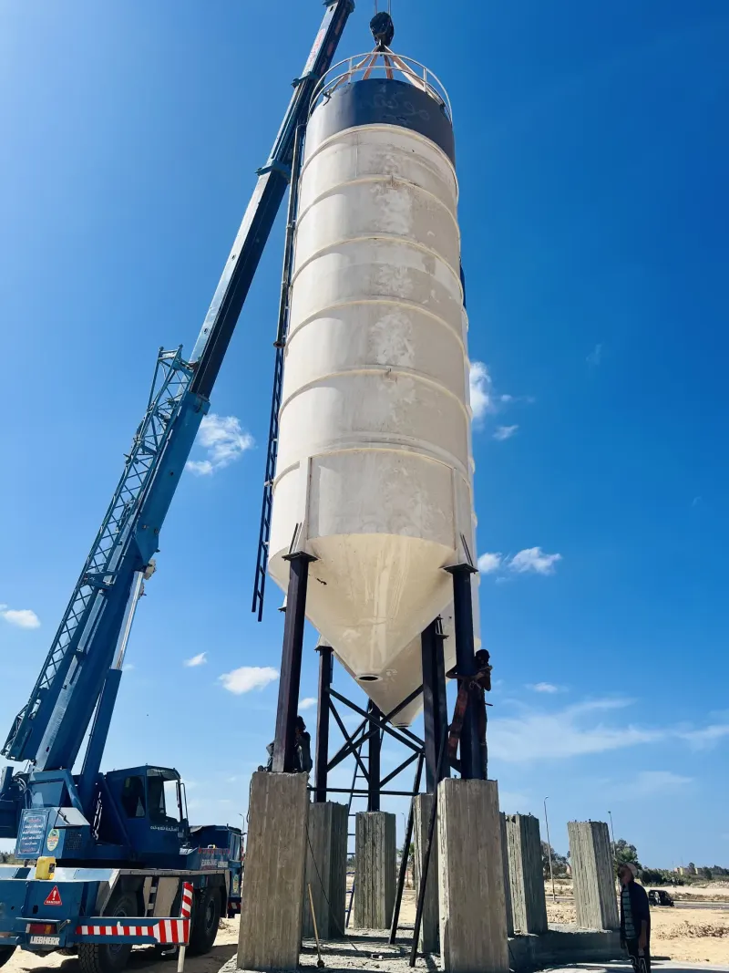Installing a cement silo with a crane