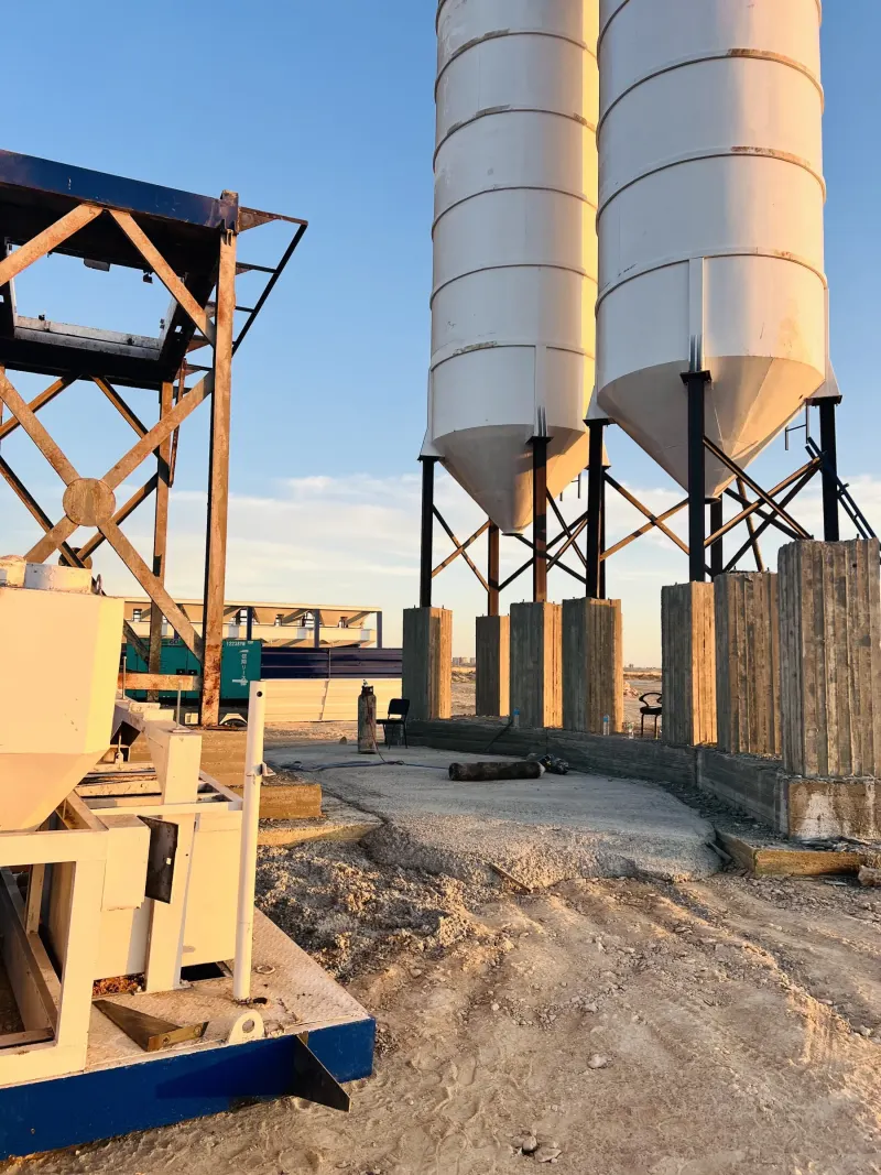 Twin cement silos on concrete foundations